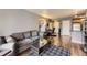 A comfortable living area with modern furniture, sleek hardwood floors, and an adjacent office space at 1623 Saint Paul St # 306, Denver, CO 80206