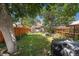 A large, grassy backyard with mature trees and privacy fencing at 2234 W 35Th Ave, Denver, CO 80211