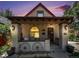 Charming front porch featuring decorative wagon wheels and exterior sconce lighting at 2234 W 35Th Ave, Denver, CO 80211