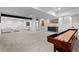 Expansive finished basement with a shuffleboard table, entertainment area, and wet bar, ideal for gatherings at 3256 S Corona, Englewood, CO 80113