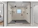 Modern bathroom showcasing a spacious glass-enclosed shower with dual shower heads and minimalist black hardware at 3256 S Corona, Englewood, CO 80113