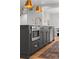 The kitchen island has an undermount microwave and stainless steel dishwasher at 3256 S Corona, Englewood, CO 80113