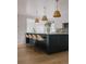Open concept kitchen features pendant lighting over an island with seating at 3256 S Corona, Englewood, CO 80113
