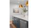 This kitchen island boasts white countertops, gray cabinets, and stainless steel appliances at 3256 S Corona, Englewood, CO 80113