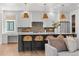 Open-concept kitchen featuring a large island, pendant lights, and a seamless flow to the living area at 3256 S Corona, Englewood, CO 80113