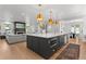 Spacious kitchen island with seating, flowing into the living room and dining area at 3256 S Corona, Englewood, CO 80113