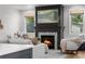 Inviting living room with a fireplace, soft seating, and natural light from windows offers a cozy atmosphere at 3256 S Corona, Englewood, CO 80113