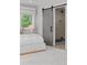 The bedroom features a gray sliding door to bathroom and a soft rug complementing the clean, inviting space at 3256 S Corona, Englewood, CO 80113