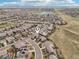 An aerial view shows a neighborhood with well-maintained homes and a nearby lake at 13960 Box Turtle Loop, Parker, CO 80134