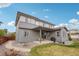 Spacious backyard with a covered patio, grill, and a pathway leading to a fire pit area at 13960 Box Turtle Loop, Parker, CO 80134