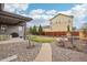 Secluded backyard with patio, lush lawn, stone pathway, and gravel at 13960 Box Turtle Loop, Parker, CO 80134
