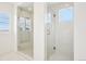 Bright bathroom featuring two glass walk-in showers with white marbled walls and bench seating at 13960 Box Turtle Loop, Parker, CO 80134