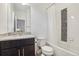 Clean bathroom offers a granite vanity, a toilet, and a shower-tub combo with mosaic tile at 13960 Box Turtle Loop, Parker, CO 80134