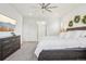 Bedroom with carpet, ceiling fan, and a large bed with white bedding and decor at 13960 Box Turtle Loop, Parker, CO 80134