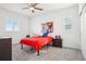 Bright bedroom with red bedspread and light colored carpet at 13960 Box Turtle Loop, Parker, CO 80134