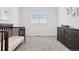 bedroom features neutral colored carpet and a dark crib at 13960 Box Turtle Loop, Parker, CO 80134