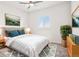 Bedroom features a modern bed with blue pillows and light colored carpet at 13960 Box Turtle Loop, Parker, CO 80134