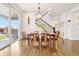 Bright dining room with hardwood floors, stylish lighting, and a large sliding glass door at 13960 Box Turtle Loop, Parker, CO 80134
