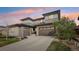Beautiful two-story home featuring a modern design, a two car garage, and colorful skies at 13960 Box Turtle Loop, Parker, CO 80134