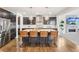 Modern kitchen island features granite countertops and seating for four at 13960 Box Turtle Loop, Parker, CO 80134