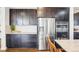 Modern kitchen with stainless steel appliances, granite countertops, and dark cabinets at 13960 Box Turtle Loop, Parker, CO 80134