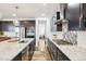 Modern kitchen with granite countertops, stainless steel appliances, and large island at 13960 Box Turtle Loop, Parker, CO 80134