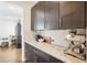 Stylish kitchen featuring sleek cabinetry, granite countertops, and stainless steel espresso machine at 13960 Box Turtle Loop, Parker, CO 80134