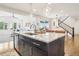 Bright, open kitchen with a large island, modern appliances, and access to the living room at 13960 Box Turtle Loop, Parker, CO 80134