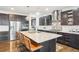 Stylish kitchen with a large island, granite countertops, stainless appliances, and pendant lighting at 13960 Box Turtle Loop, Parker, CO 80134