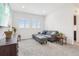 Living room with a grey sofa and an ottoman with a view out the window at 13960 Box Turtle Loop, Parker, CO 80134