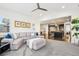 Open-concept living room with large sectional couch connecting to the modern kitchen at 13960 Box Turtle Loop, Parker, CO 80134