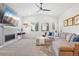 Inviting living room boasts a fireplace, large TV, and a comfortable sectional sofa at 13960 Box Turtle Loop, Parker, CO 80134