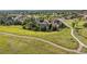 Aerial view of a residential community with walking path, showcasing houses and landscaping at 10660 Weathersfield Ct, Highlands Ranch, CO 80129