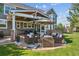 Spacious backyard with an outdoor seating area, patio, and well-manicured lawn at 10660 Weathersfield Ct, Highlands Ranch, CO 80129
