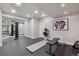 Basement workout area with mirrored wall, rubber flooring, and workout equipment at 10660 Weathersfield Ct, Highlands Ranch, CO 80129