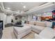 Spacious basement featuring seating, workout equipment, neutral colors, and recessed lighting at 10660 Weathersfield Ct, Highlands Ranch, CO 80129