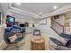 Finished basement with entertainment area, including a game console and a comfortable seating arrangement at 10660 Weathersfield Ct, Highlands Ranch, CO 80129