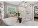 Bright bathroom featuring a stand alone soaking tub and a glass enclosed shower with double shower heads at 10660 Weathersfield Ct, Highlands Ranch, CO 80129