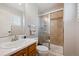 Bathroom featuring a wood vanity and a glass enclosed shower with a tile surround at 10660 Weathersfield Ct, Highlands Ranch, CO 80129