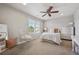 Bedroom with a hanging chair, large windows, and white furnishings for a bright and airy space at 10660 Weathersfield Ct, Highlands Ranch, CO 80129
