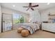 Bedroom featuring a full length mirror, a large window and boho decor at 10660 Weathersfield Ct, Highlands Ranch, CO 80129