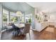 Bright dining area featuring a modern light fixture, bench seating, and views of the backyard at 10660 Weathersfield Ct, Highlands Ranch, CO 80129