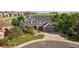 Charming two-story home featuring a landscaped yard, covered porch, and attached two-car garage with brick accents at 10660 Weathersfield Ct, Highlands Ranch, CO 80129