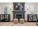 Elegant fireplace with a dark gray mantle, marble hearth, and display cabinets providing storage and style at 10660 Weathersfield Ct, Highlands Ranch, CO 80129