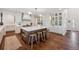 Spacious kitchen with a large island, wooden stools, and abundant storage in white cabinetry at 10660 Weathersfield Ct, Highlands Ranch, CO 80129