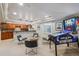 Comfortable living room with sleek design, including a wet bar, ample seating, and games at 10660 Weathersfield Ct, Highlands Ranch, CO 80129