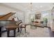 Elegant living area with a grand piano, comfortable seating, and ample natural light, ideal for entertaining guests at 10660 Weathersfield Ct, Highlands Ranch, CO 80129