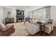 Comfortable living room with a fireplace, bay window and neutral decor perfect for Gathering gatherings and relaxing at 10660 Weathersfield Ct, Highlands Ranch, CO 80129