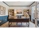 Inviting home office featuring custom built-ins, a large desk, and a window overlooking the outdoors at 10660 Weathersfield Ct, Highlands Ranch, CO 80129