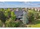 Aerial view of the backyard and covered patio showcasing the lush landscaping and peaceful outdoor living space at 10660 Weathersfield Ct, Highlands Ranch, CO 80129